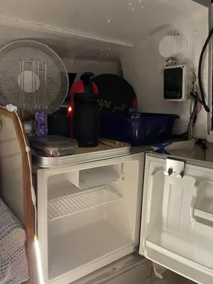 an open refrigerator with a fan on top of it at Symbiose sur l’eau Gruissan in Gruissan
