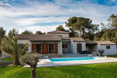 a villa with a swimming pool in front of a house at villa queen-south IT in Ventenac-Cabardès