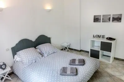 a bedroom with a large bed with two plates on it at villa queen-south IT in Ventenac-Cabardès