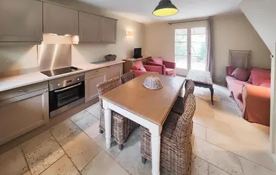 a kitchen with a dining table and a living room at Gorgeous Home In Saint-Laurent-De-La-Ca in Saint-Laurent-de-la-Cabrerisse