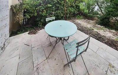 a blue table and a chair on a patio at Gorgeous Home In Saint-Laurent-De-La-Ca in Saint-Laurent-de-la-Cabrerisse
