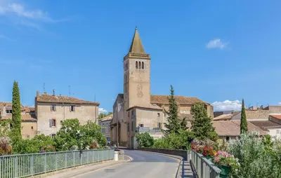 a road leading to a building with a clock tower at Gorgeous Home In Saint-Laurent-De-La-Ca in Saint-Laurent-de-la-Cabrerisse