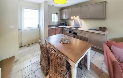 a kitchen with a wooden table and chairs at Gorgeous Home In Saint-Laurent-De-La-Ca in Saint-Laurent-de-la-Cabrerisse