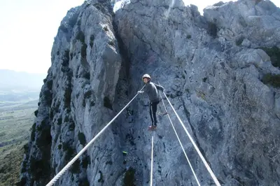 a person on a rope bridge on a mountain at Gîte Les Mimosas in Prugnanes