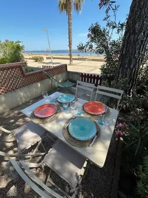a table with plates and glasses on top of it at VILLA DU PIN in Gruissan