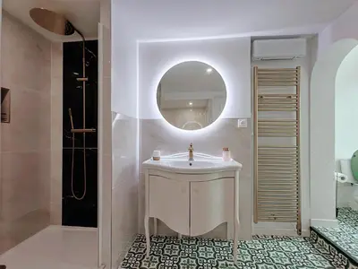 a bathroom with a sink and a mirror at Appartement Bulle d'antan en cœur de ville - Monument classé historique - Grand Jaccuzi in Castres