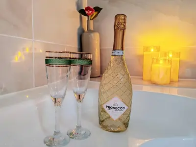 a bottle of champagne and two wine glasses on a counter at Appartement Bulle d'antan en cœur de ville - Monument classé historique - Grand Jaccuzi in Castres