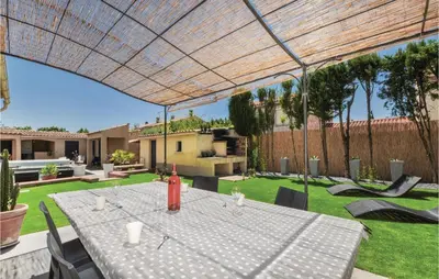 an outdoor patio with a table and chairs at 4 Bedroom Awesome Home In Narbonne in Narbonne