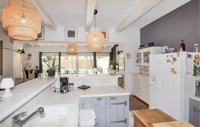 a kitchen with white counters and a white refrigerator at 4 Bedroom Awesome Home In Narbonne in Narbonne