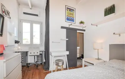 a bedroom with a bed and a desk and a table at 4 Bedroom Awesome Home In Narbonne in Narbonne