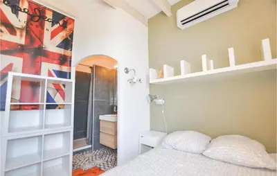 a bedroom with a bunk bed and a bathroom at 4 Bedroom Awesome Home In Narbonne in Narbonne