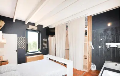 a bedroom with a white bed and a window at 4 Bedroom Awesome Home In Narbonne in Narbonne