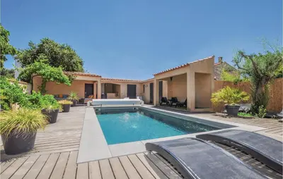 a swimming pool in the backyard of a house at 4 Bedroom Awesome Home In Narbonne in Narbonne