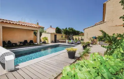 a backyard with a swimming pool and a house at 4 Bedroom Awesome Home In Narbonne in Narbonne