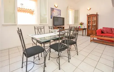 a living room with a table and chairs at Holiday Home Cessenon Sur Orb Mn-1265 in Cessenon