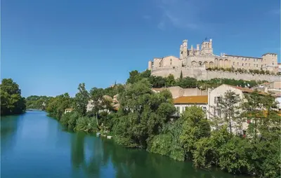 a view of a river with a castle in the background at Holiday Home Cessenon Sur Orb Mn-1265 in Cessenon