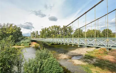 a bridge over a river with trees and a sky at Holiday Home Cessenon Sur Orb Mn-1265 in Cessenon