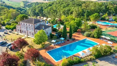 an aerial view of a large house with a swimming pool at Mobil Home XXL 4 chambres - Camping Tarn - Domaine du Koukano in Maurens-Scopont