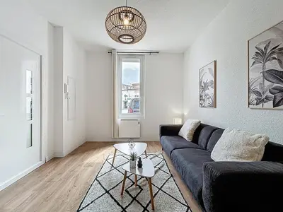 a living room with a couch and a table at Le Cocon - Wifi - Cour privative - Proche Halles in Narbonne