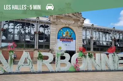 a building with a large sign in front of it at Le Cocon - Wifi - Cour privative - Proche Halles in Narbonne