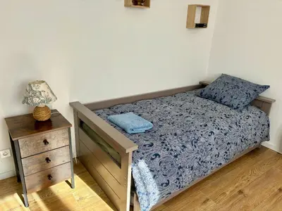a small bedroom with a bed and a night stand at Maison Tulipe in Puivert