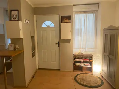 a hallway with a white door and a window at Charmant Studio in Vinassan