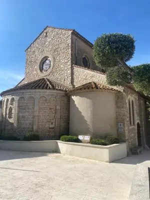 an old stone church with a clock on it at Charmant Studio in Vinassan