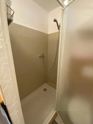 a shower with a glass door in a bathroom at Charmant Studio in Vinassan