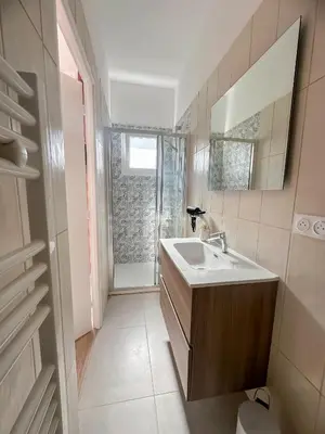 a bathroom with a sink and a mirror at Face Cité - Chambres D'Hôtes - Parking & Garage Gratuit - Wi-Fi Gratuit in Carcassonne