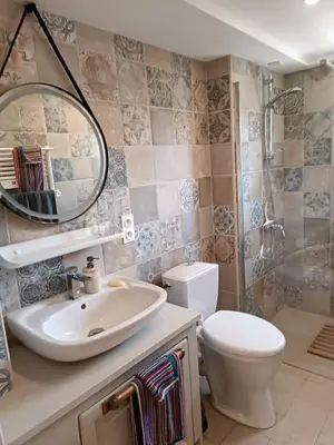a bathroom with a sink and a toilet and a mirror at Coste de Laval in Quillan