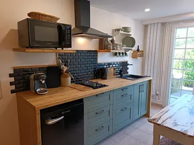 a kitchen with a microwave and a stove top oven at Coste de Laval in Quillan