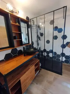 a bathroom with a sink and a shower at Amé-lys in Véraza