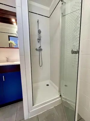 a bathroom with a shower with a glass door at Zen studio ※ parking - piscine in Carcassonne