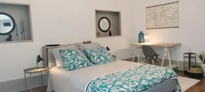 a bedroom with a bed and a table and a desk at Grand Appartement Hyper Centre Castres 5 Chambres 10 personnes in Castres