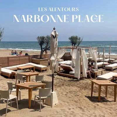 a beach with tables and chairs and the ocean at Appartement central à Castelnaudary in Castelnaudary