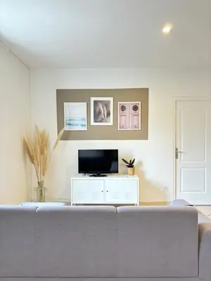 a living room with a couch and a tv at Appartement central à Castelnaudary in Castelnaudary