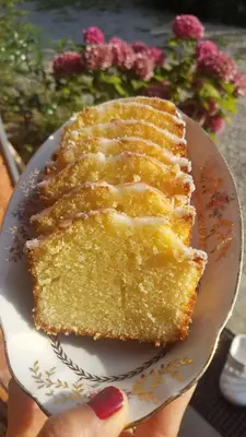 a person holding a piece of cake on a plate at B&B La Ferme de Loubens in Loubens-Lauragais