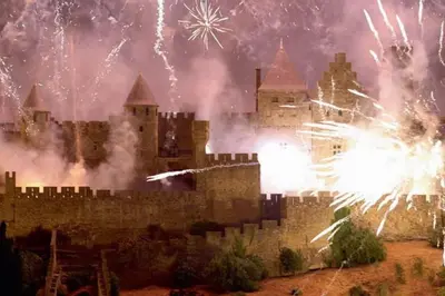 a castle with fireworks in front of it at Le studio de Simon au pied de la cité in Carcassonne