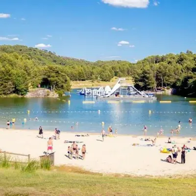 a group of people on a beach near a lake at Le studio de Simon au pied de la cité in Carcassonne