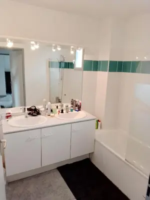 a bathroom with a sink and a tub and a mirror at Agréable pavillon in Nailloux
