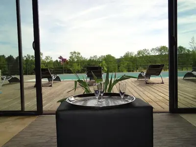 a table with a wine glass on top of it at Villa contemporaine à la campagne - Promo rentrée in Saint-Papoul