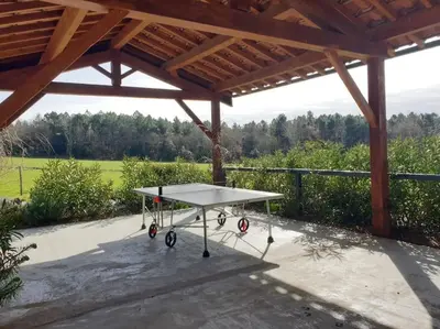 a ping pong table sitting under a pavilion at Villa contemporaine à la campagne - Promo rentrée in Saint-Papoul