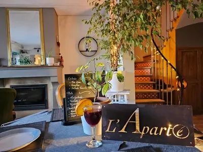 a table with a wine glass on top of it at L Aparté en Corbières in Ferrals-lès-Corbières
