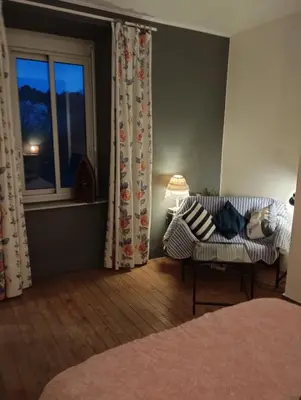 a living room with a couch and a window at L Aparté en Corbières in Ferrals-lès-Corbières