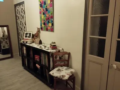 a room with a book shelf and a chair at L Aparté en Corbières in Ferrals-lès-Corbières