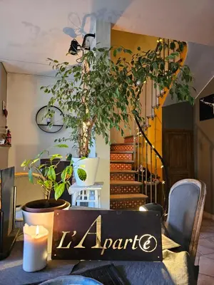 a dining room with a table with a sign on it at L Aparté en Corbières in Ferrals-lès-Corbières