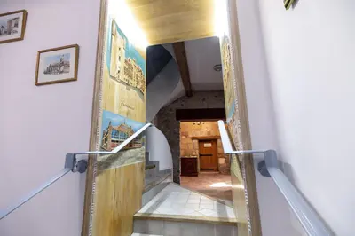 a staircase in a house with a view of a room at Petit studio presbytère dans L'Église in Narbonne