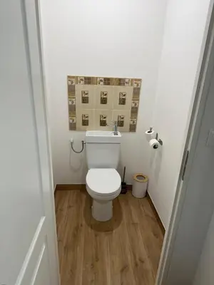a bathroom with a white toilet in a room at Petit studio presbytère dans L'Église in Narbonne