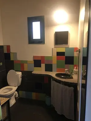 a colorful bathroom with a toilet and a sink at BelCiano (ancien Toit Vert) in Fitou