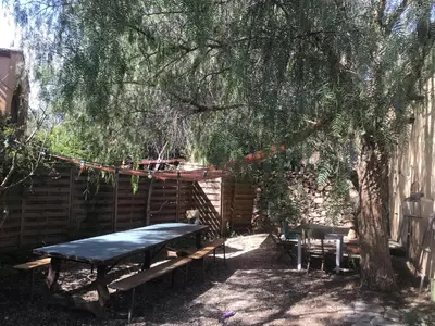 a picnic table and a swing under a tree at BelCiano (ancien Toit Vert) in Fitou